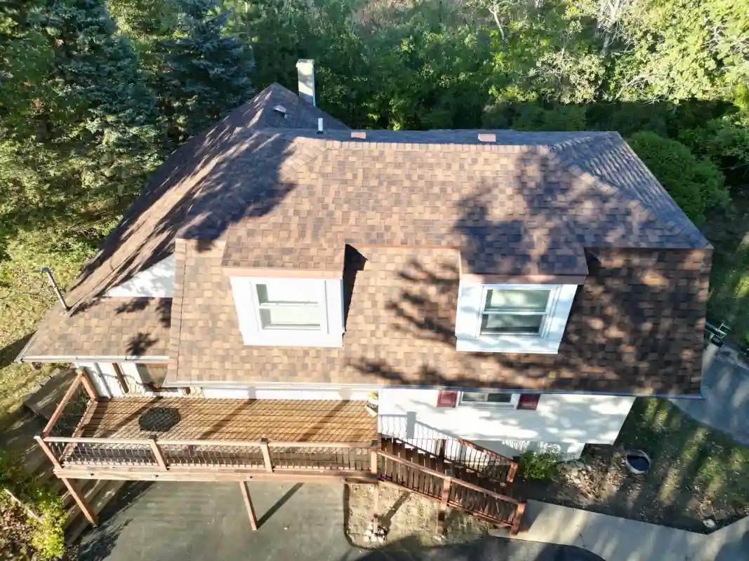 Roofing project showing completed shingle installation and roof repair