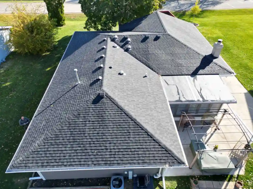 Completed residential roofing project with new shingles installed