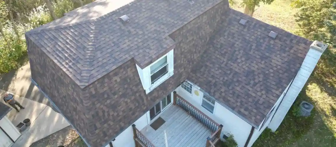 Finished roof replacement project showing new shingles and improved exterior