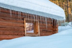 Icicles hanging from roof edge indicating ice buildup and winter roof issues